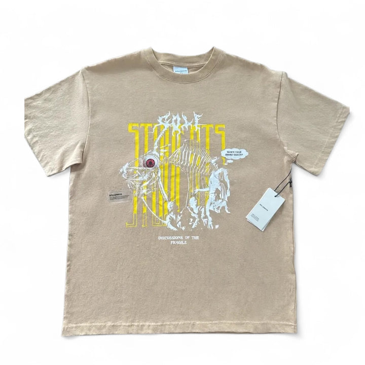Student Golf Discussions Tshirt -Monarch in soft beige with graphic design and tag attached.