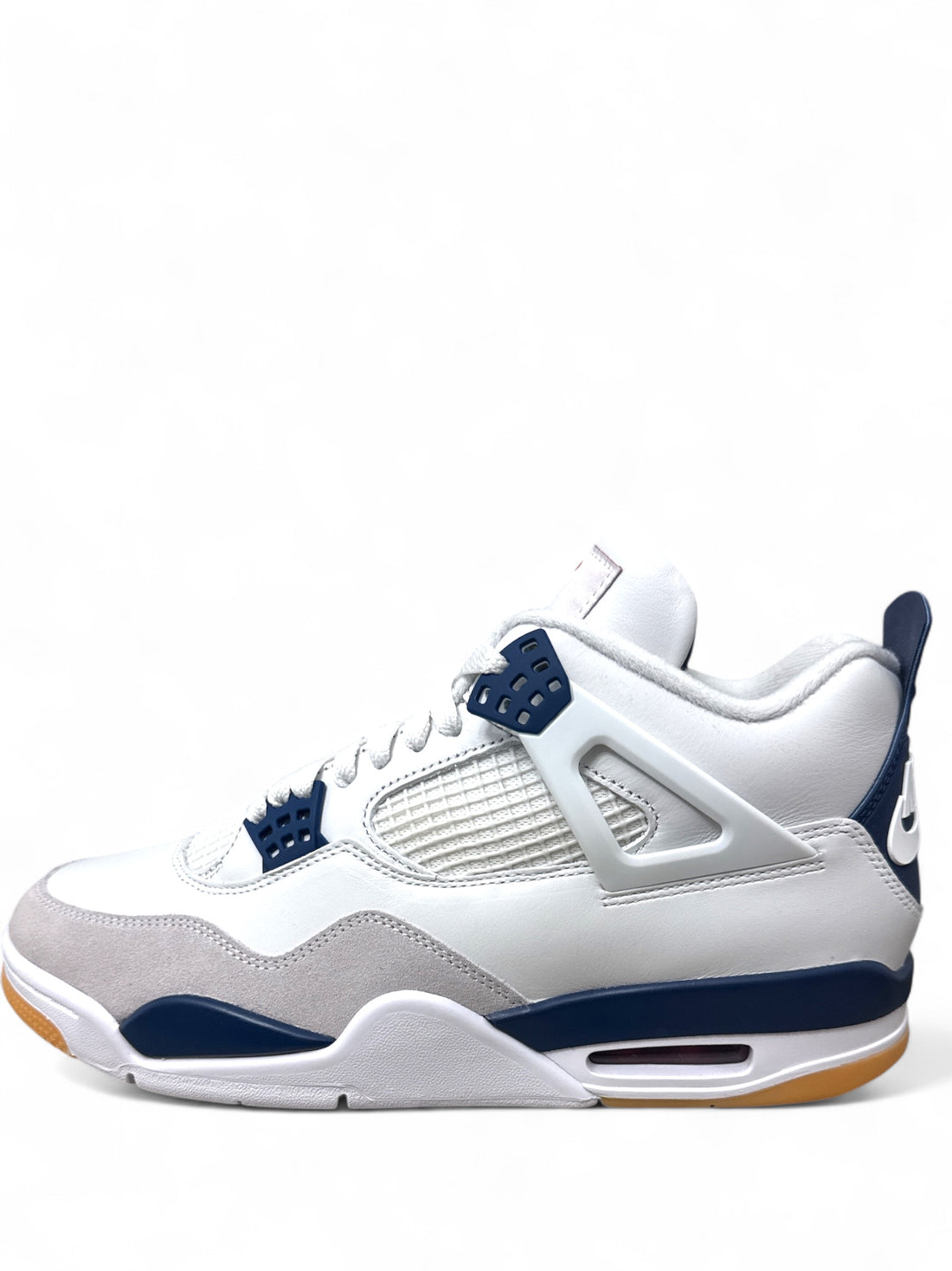 Jordan 4 Retro SB Navy sneakers side view showcasing white and navy colorway with gum sole.
