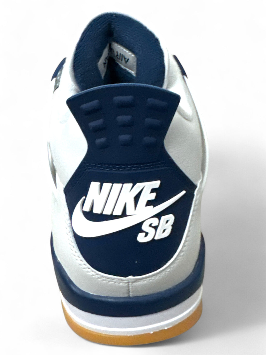 Back view of Jordan 4 Retro SB Navy sneakers showcasing the Nike SB branding and design.