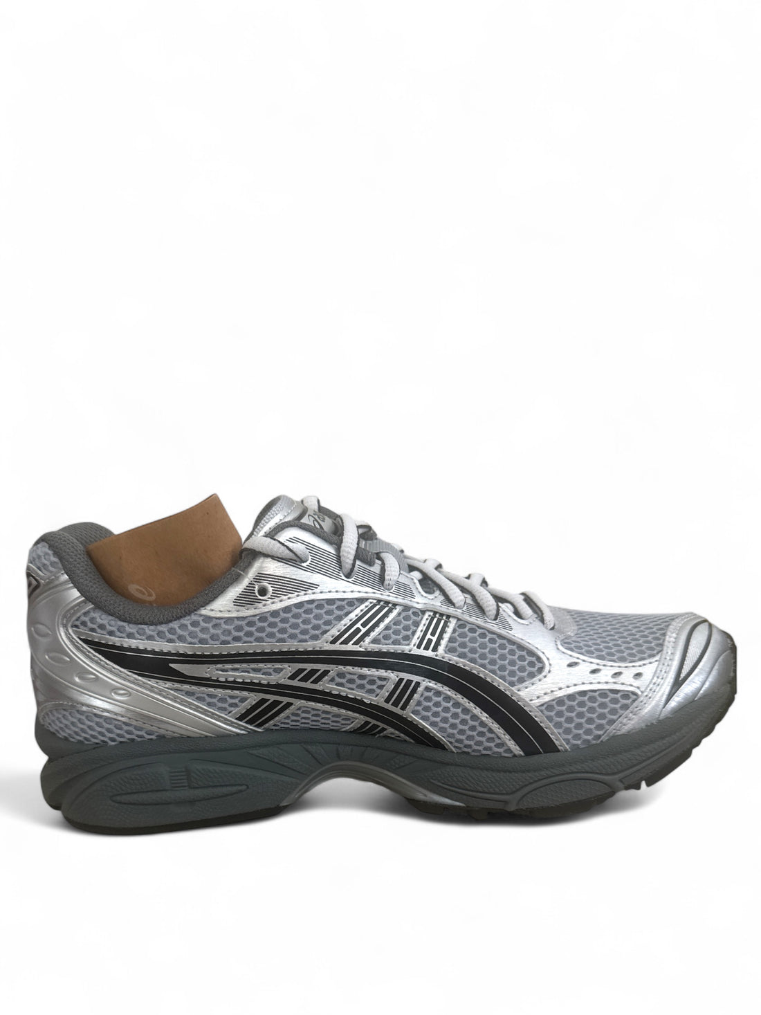 ASICS Gel-Kayano 14 running shoes in silver with black accents and breathable mesh detail.