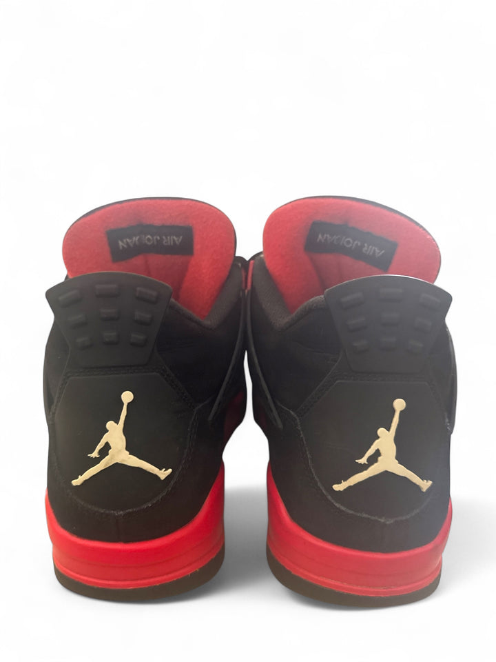 Back view of pre-owned Jordan 4 Retro Red Thunder sneakers showcasing black and red design and iconic Jumpman logo.