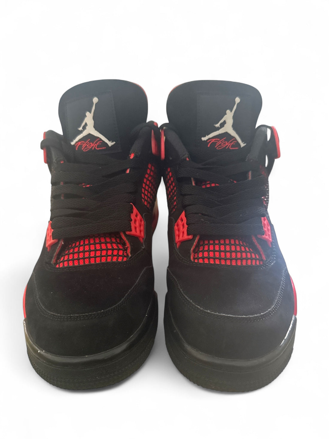 pre-owned Jordan 4 Retro Red Thunder showing bold red and black contrasts with premium nubuck construction.