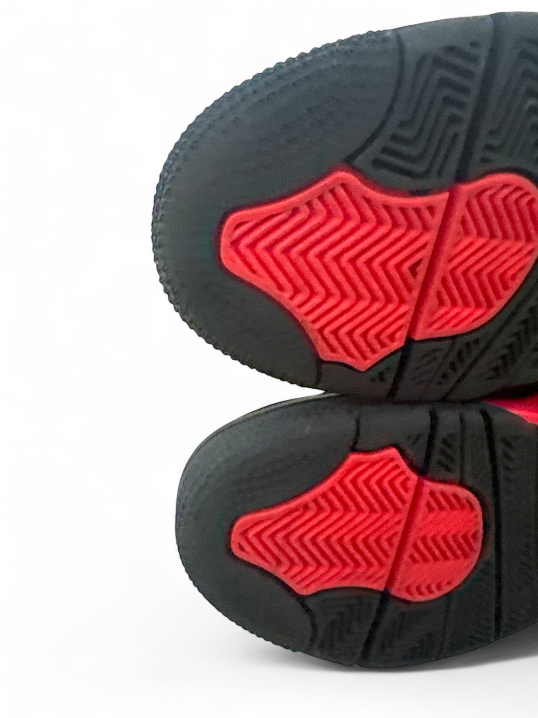 pre-owned Jordan 4 Retro Red Thunder sneaker outsole showing red and black rubber design.