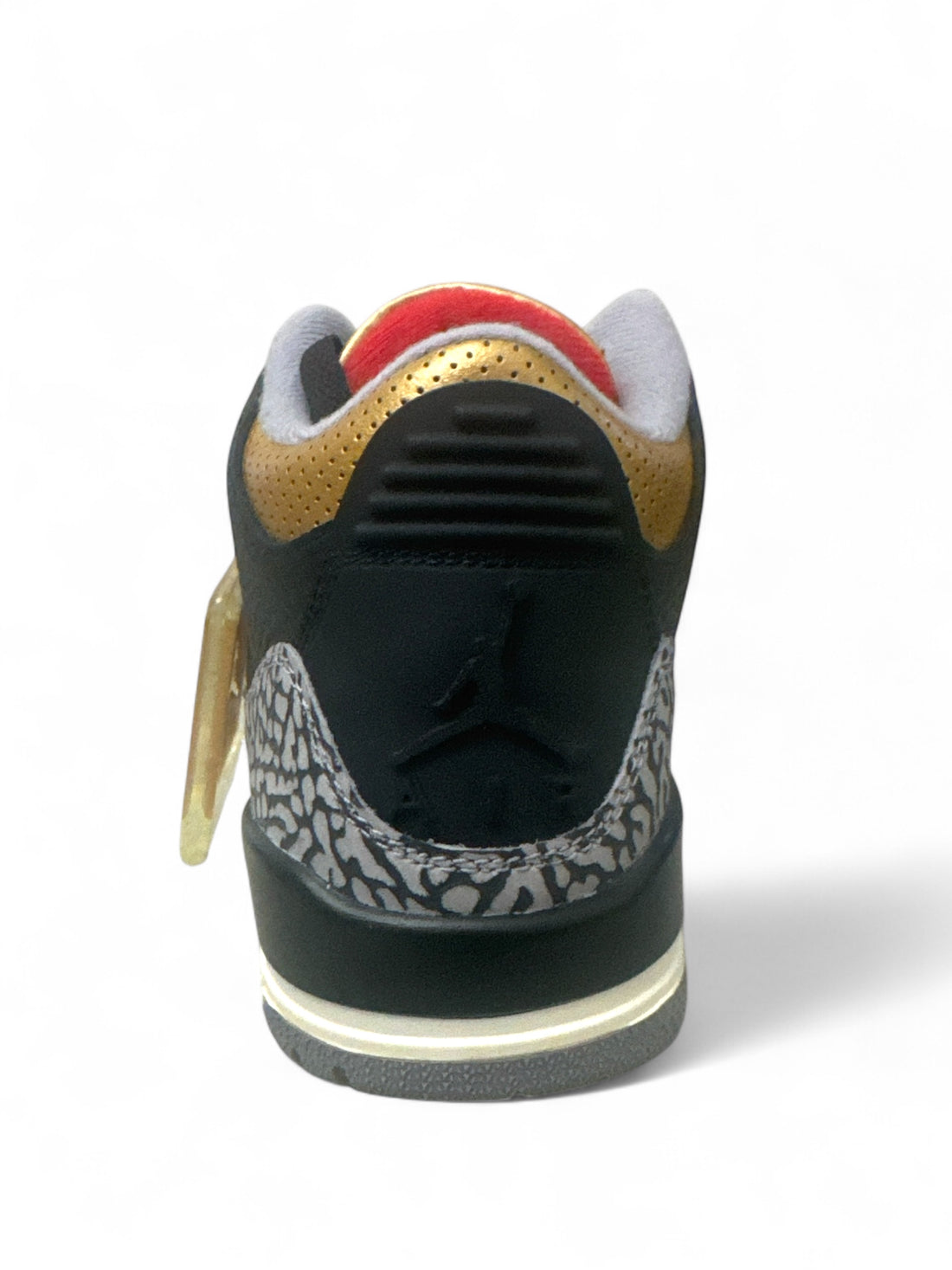 Back view of Jordan 3 Retro Black Cement Gold sneaker showcasing premium leather and gold accents.