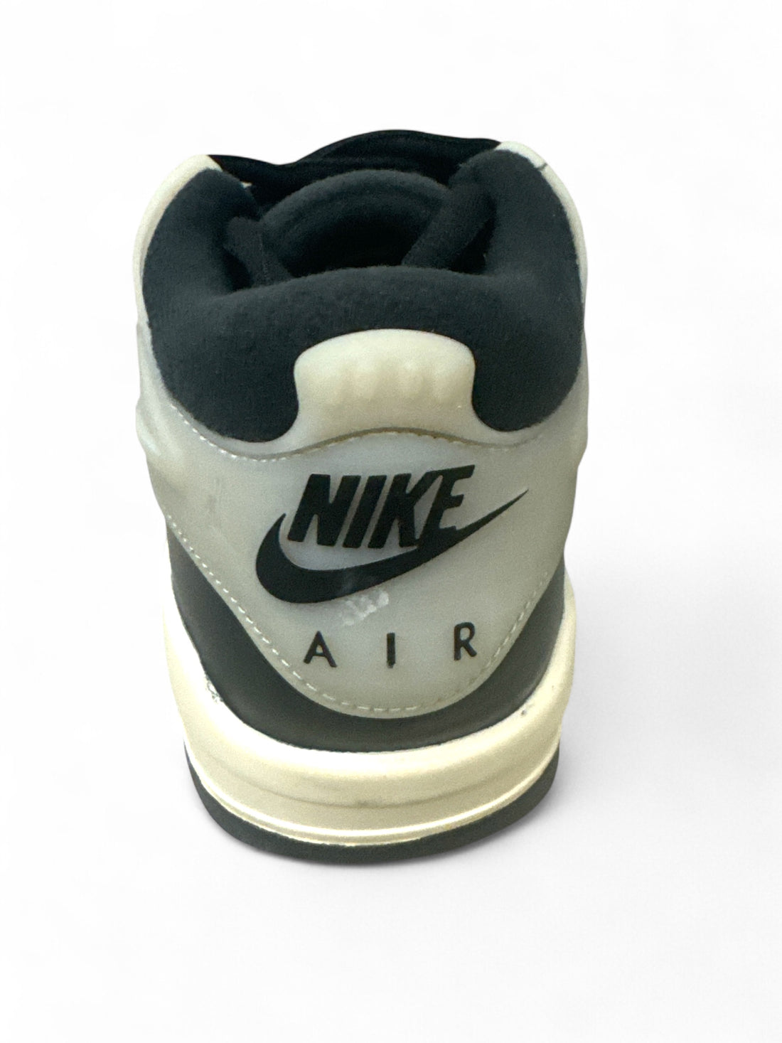 Back view of Nike Air sneakers highlighting logo, perfect for sporty fashion lovers. Jordan 4 Black Sail GS sneakers.