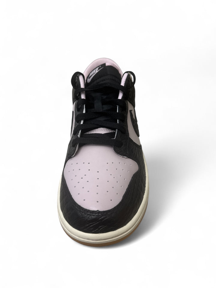 Nike Dunk Low Retro Pink Foam Black sneaker with black laces and unique design.