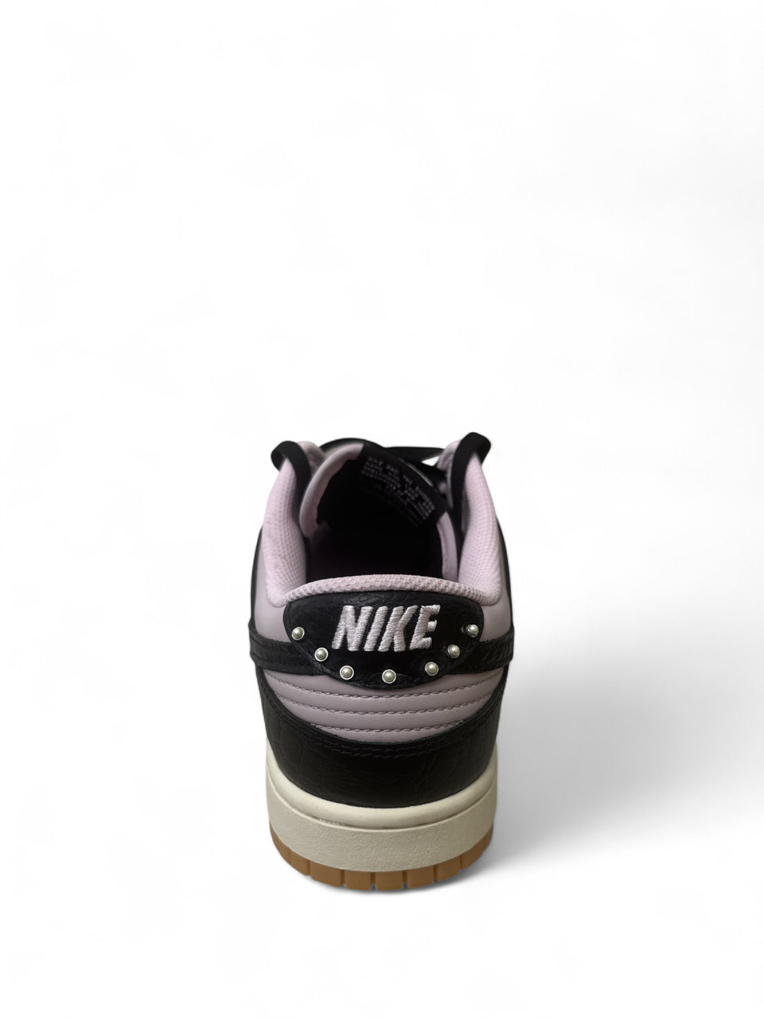 Back view of Nike Dunk Low Retro Pink Foam Black without box, showcasing unique design and branding.
