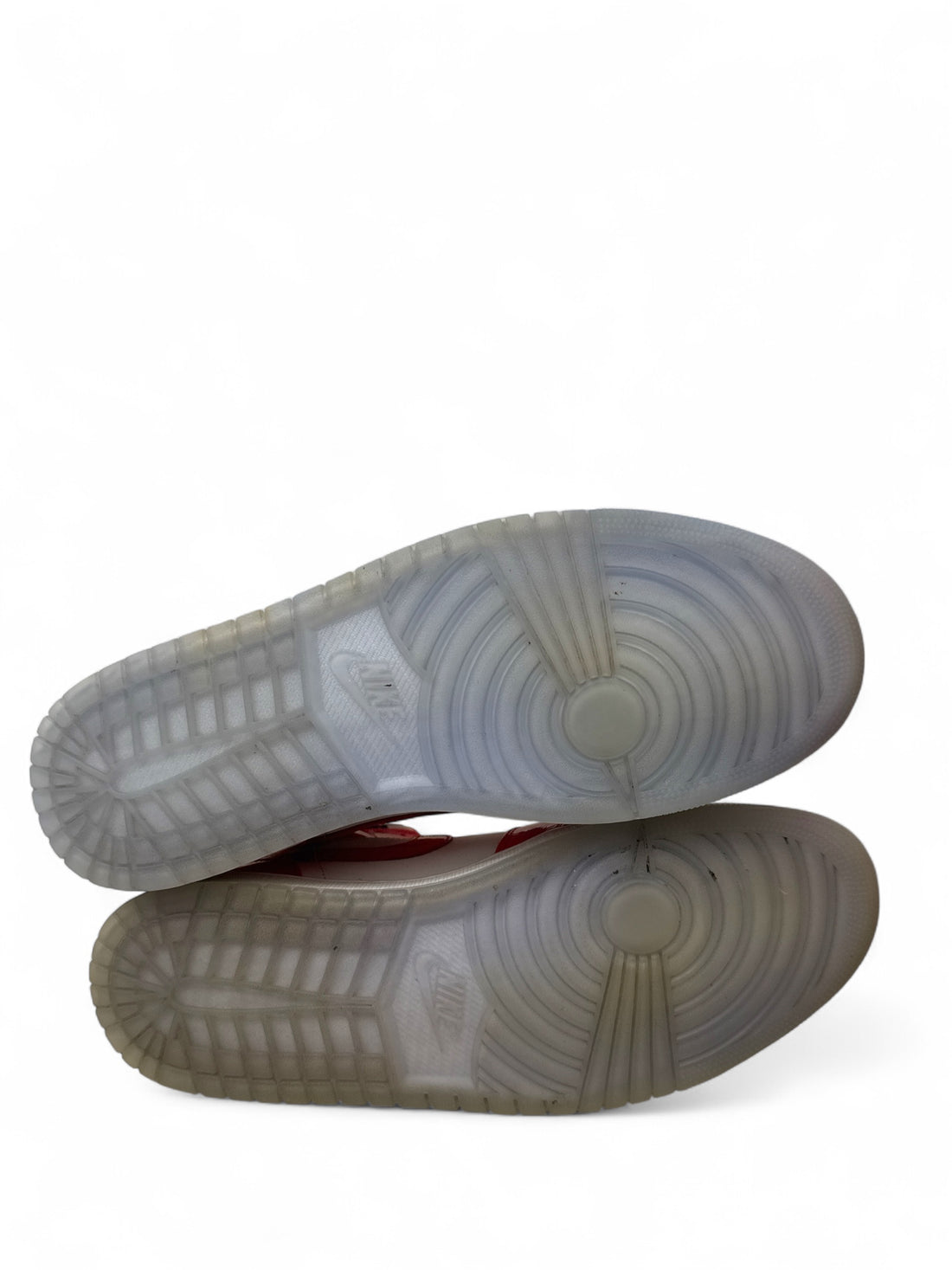 pre-owned Jordan 1 Mid Barcelona shoe soles showing unique ice bottom and design details.