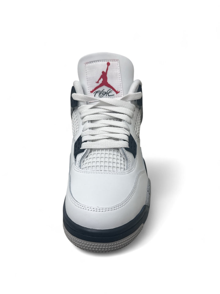 Top view of Jordan 4 Retro White Cement sneaker showcasing white leather and cement details.