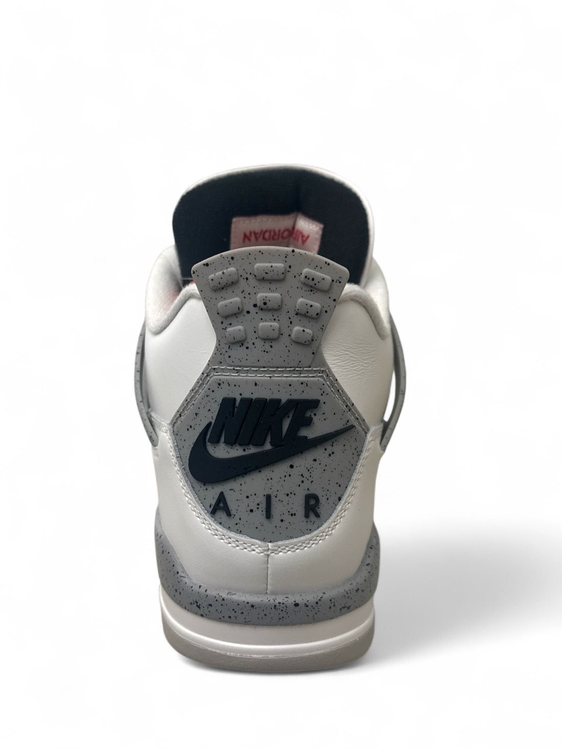 Back view of Jordan 4 Retro White Cement sneaker showcasing Nike Air branding and cement accents.