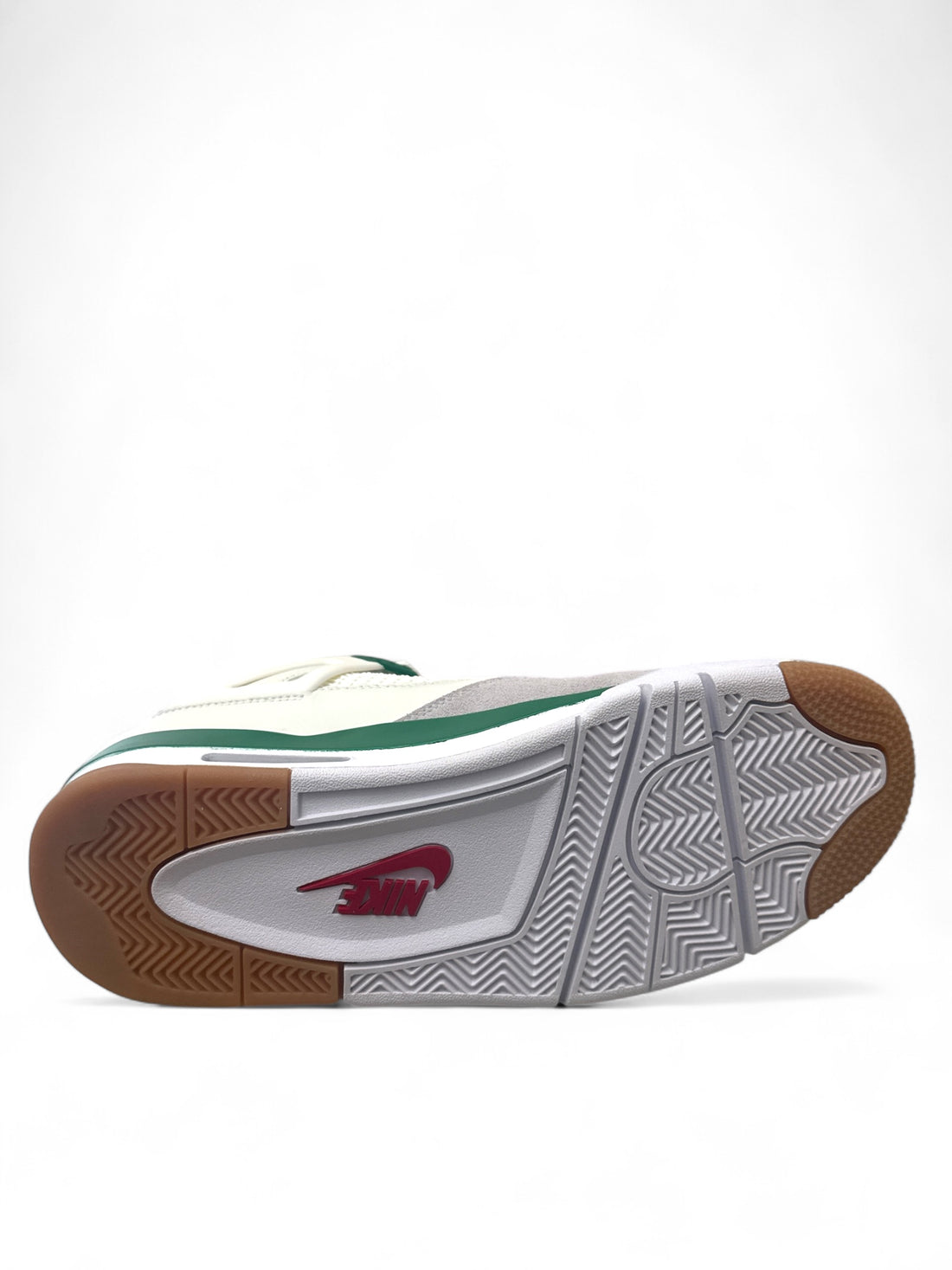 Bottom view of Jordan 4 Retro SB Pine Green sneaker showing traction pattern and design details.