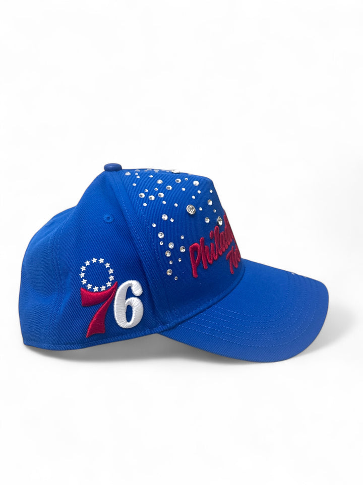 Philadelphia 76ers rhinestone snapback hat side view with blue fabric and sparkling rhinestones.
