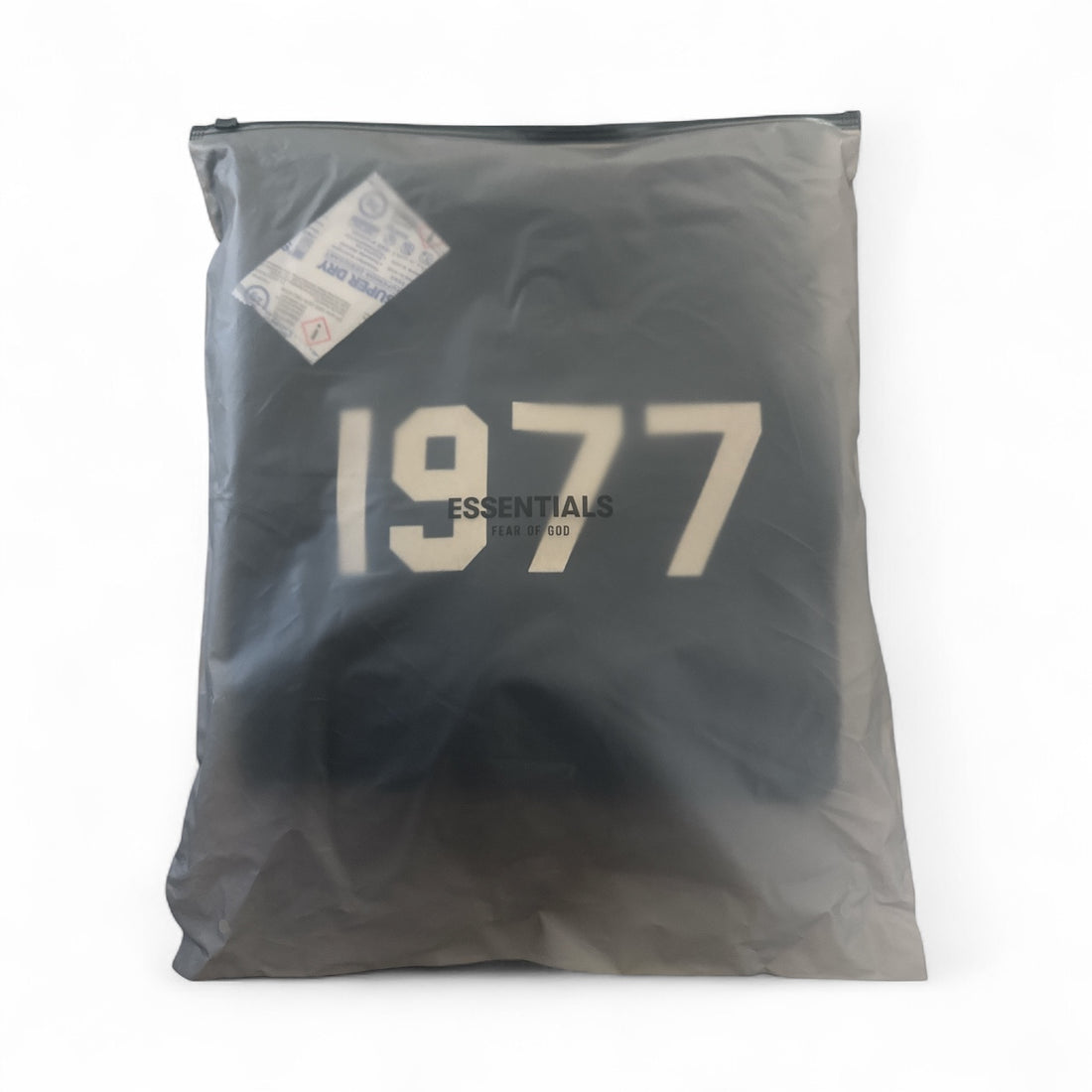 Fear of God Essentials hoodie packaged in a clear bag, featuring the year '1977' and the Essentials logo.